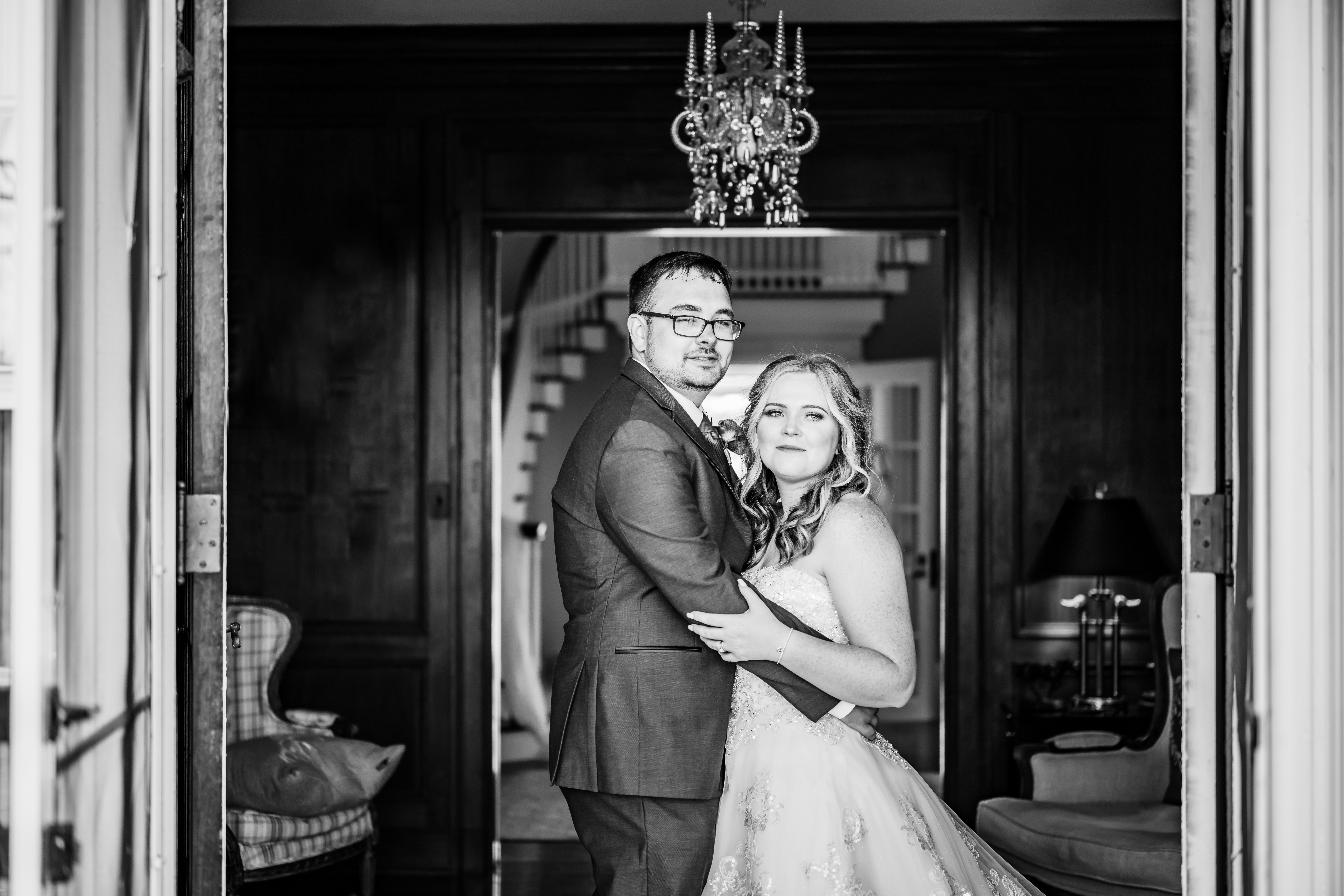 black and white wedding photo of bride and groom embracing