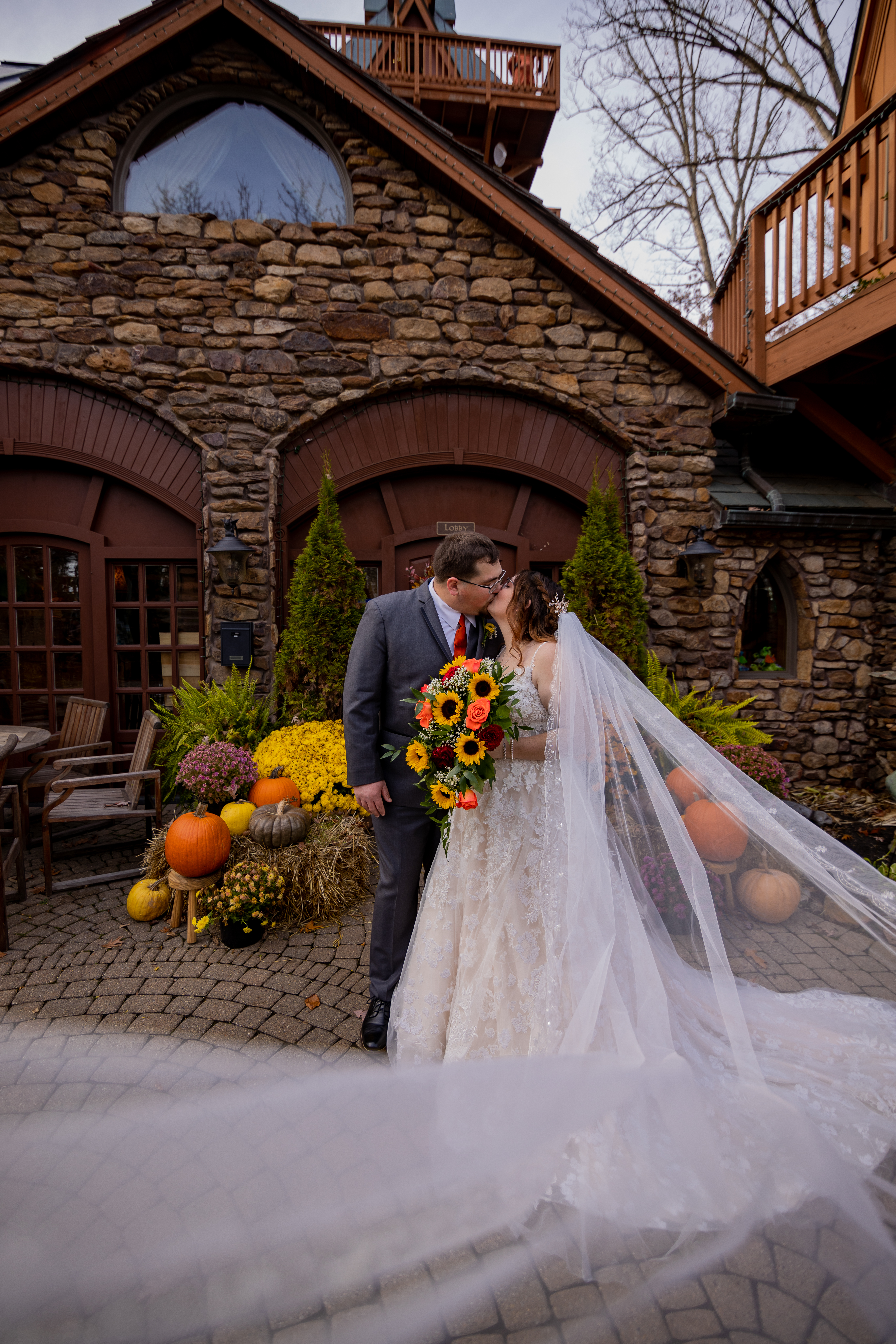 bride and groom kissing during fall wedding