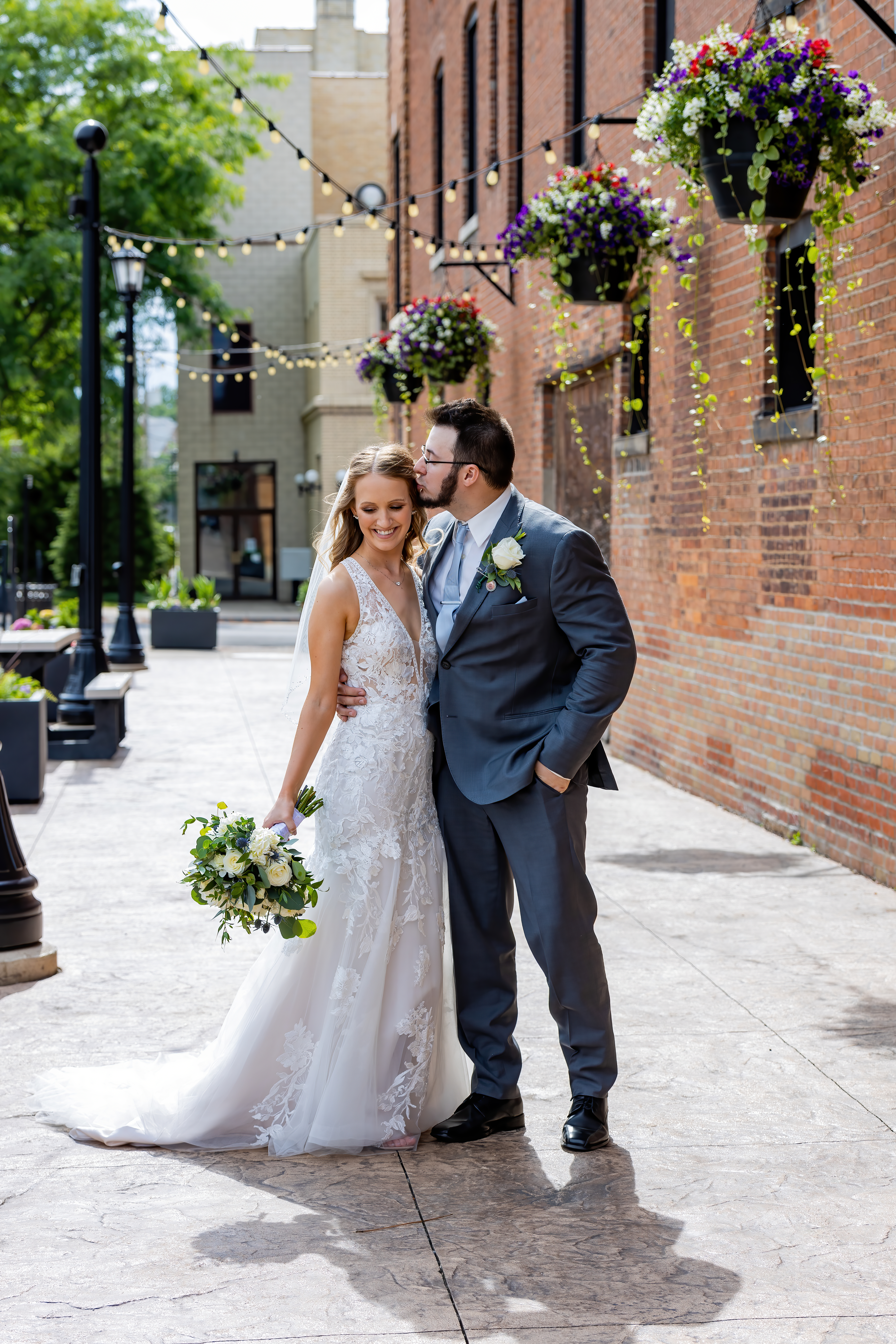 groom kissing bride on the forehead