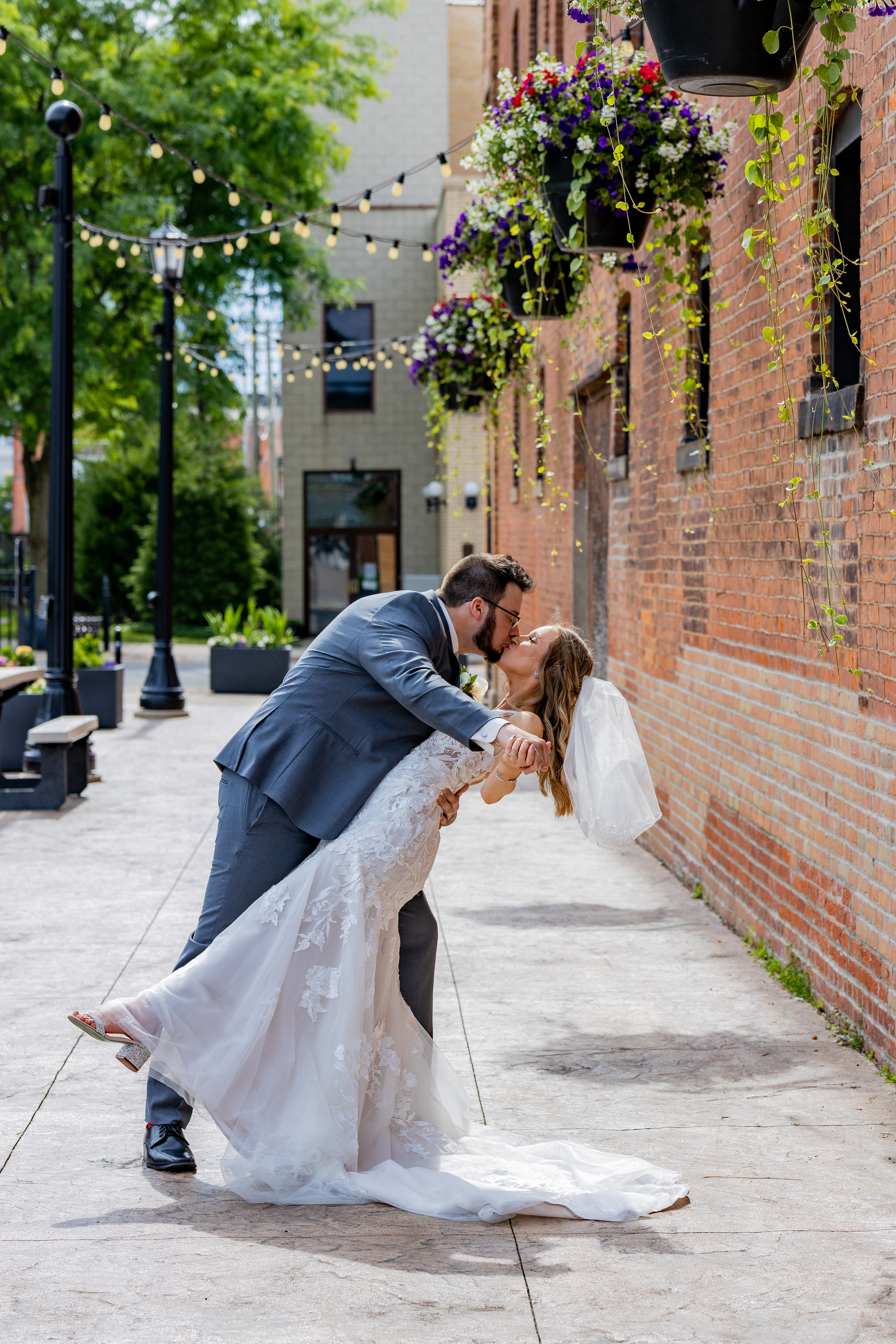 bride and groom kissing on downtown street