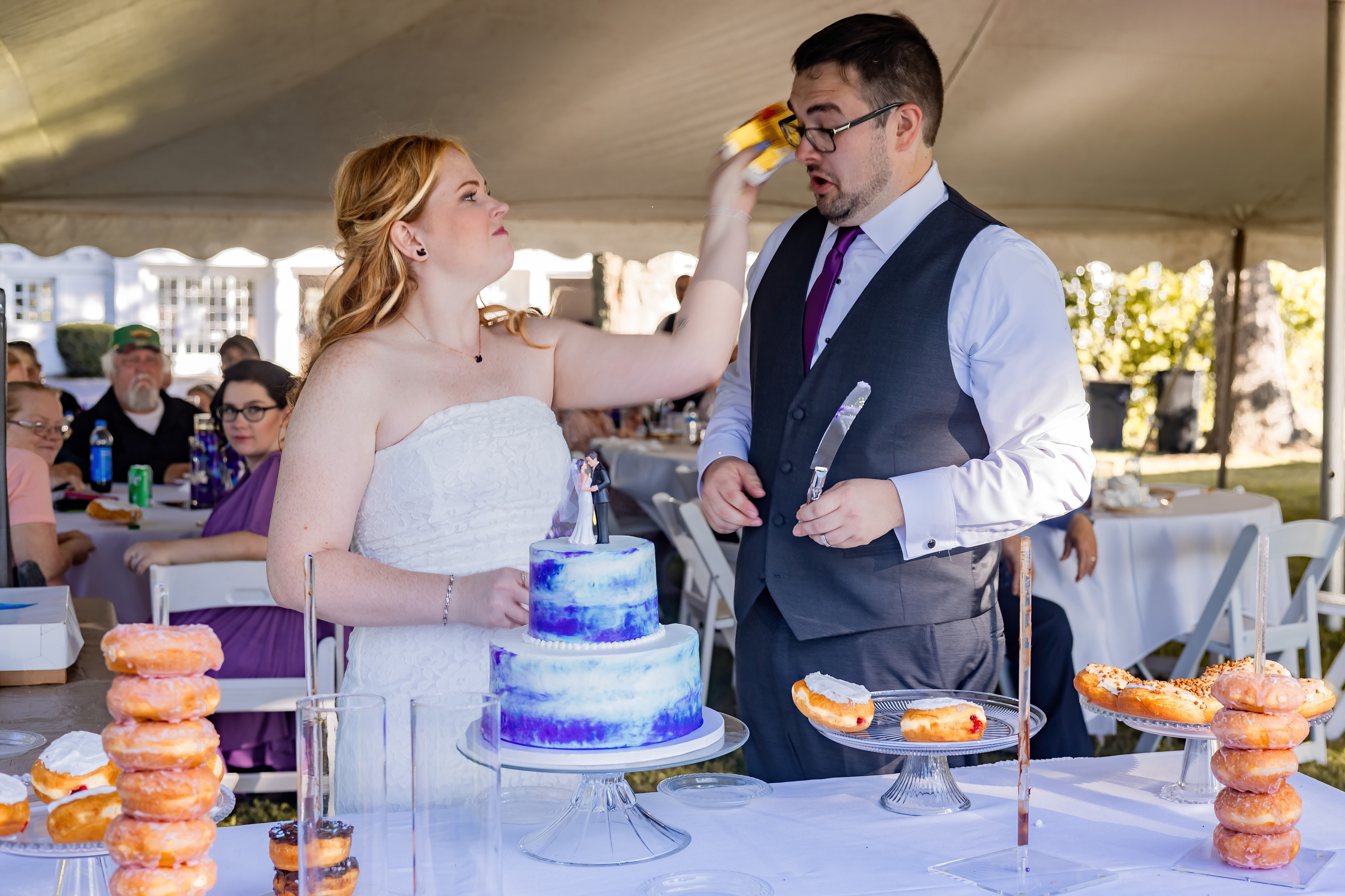 bride smashing cake in groom's face