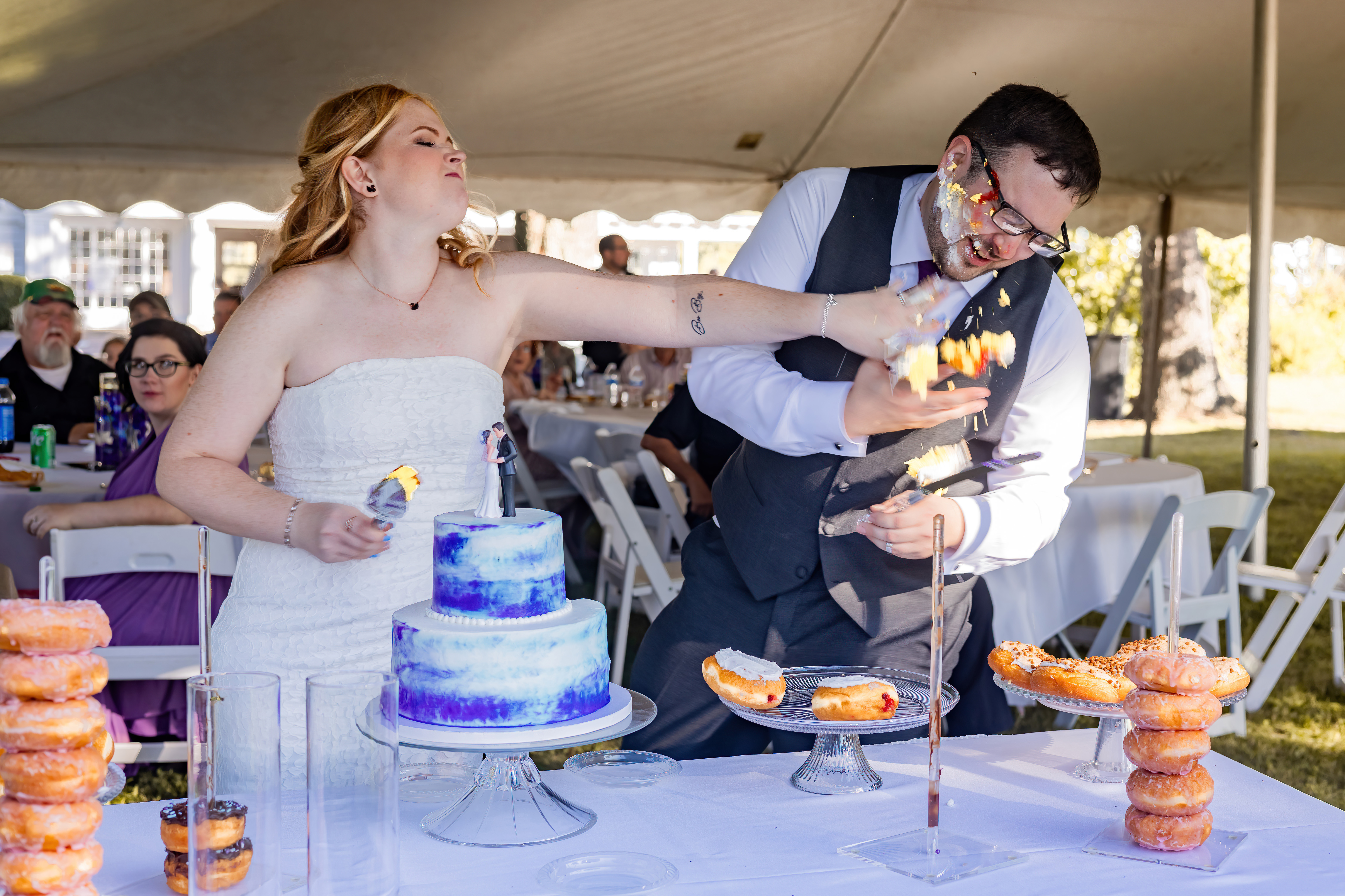 bride smashing cake in groom's face