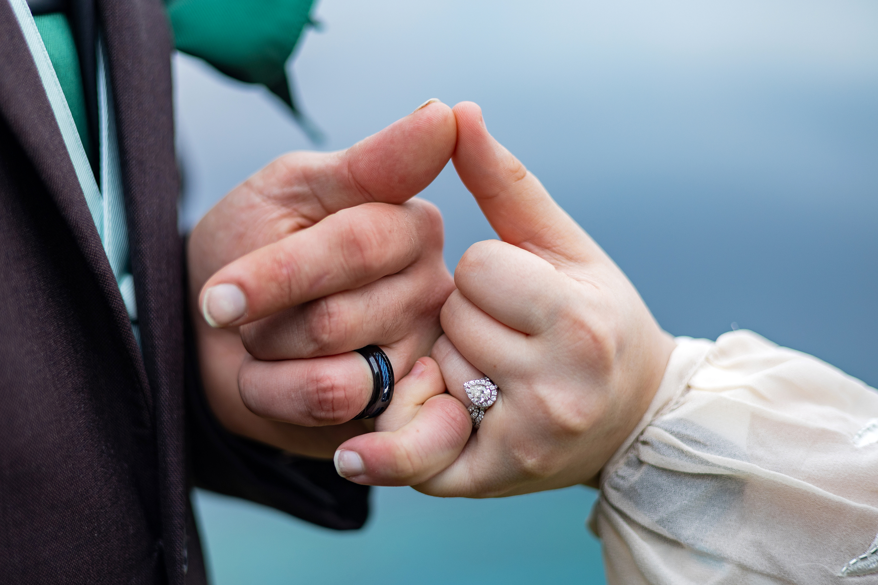 bride and groom making pinky promise