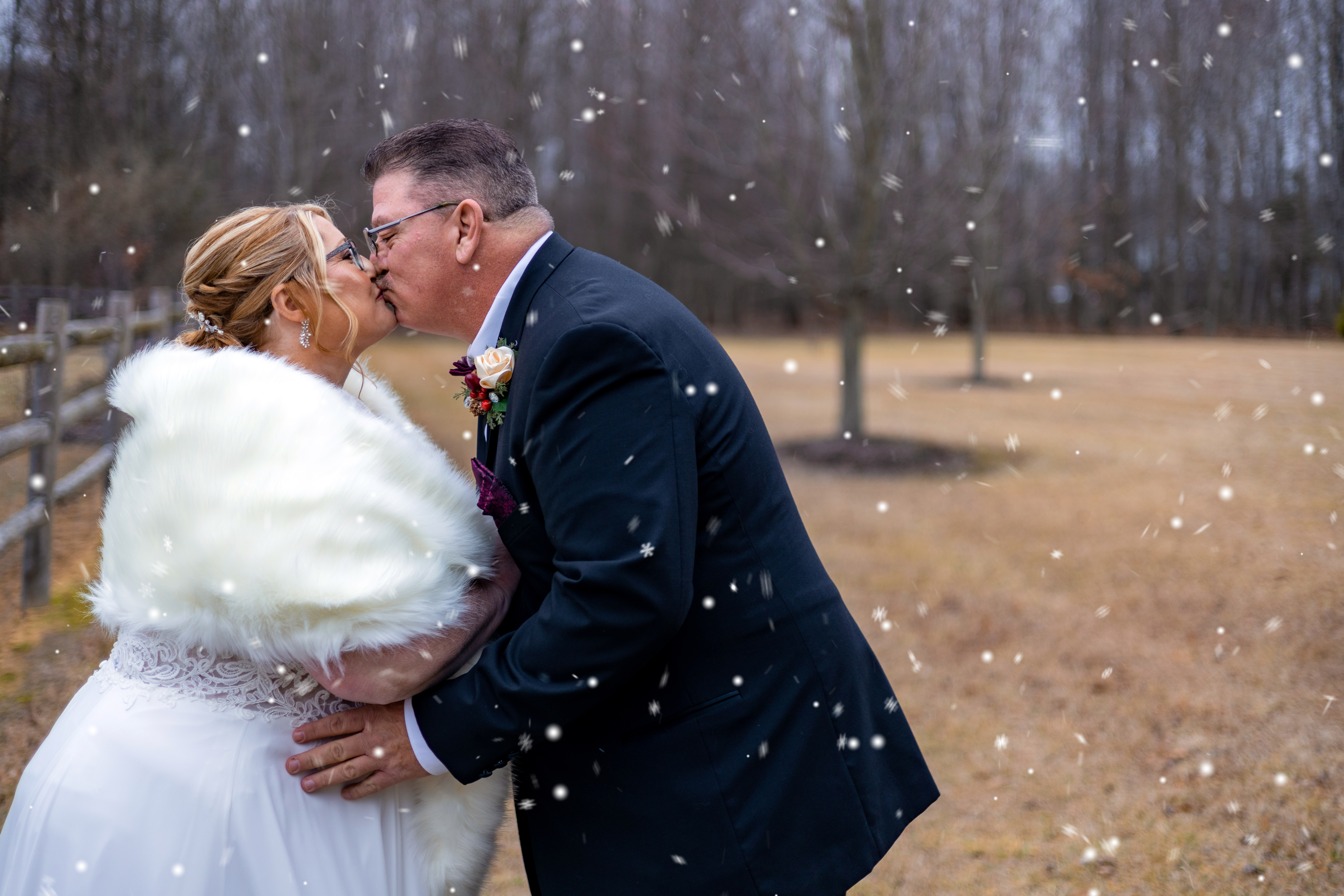 bride and groom kissing in the snow