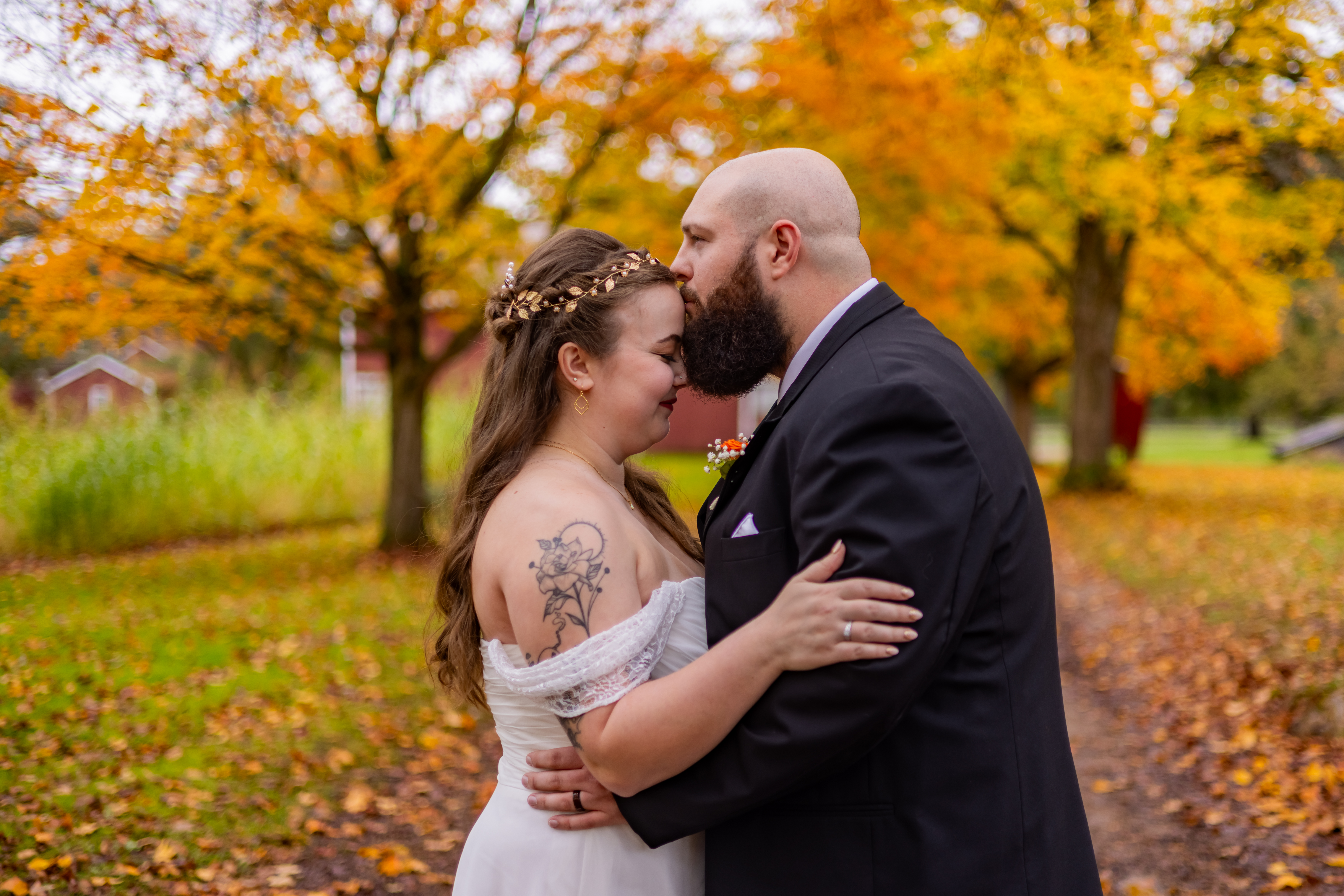 groom kissing bride on forehead