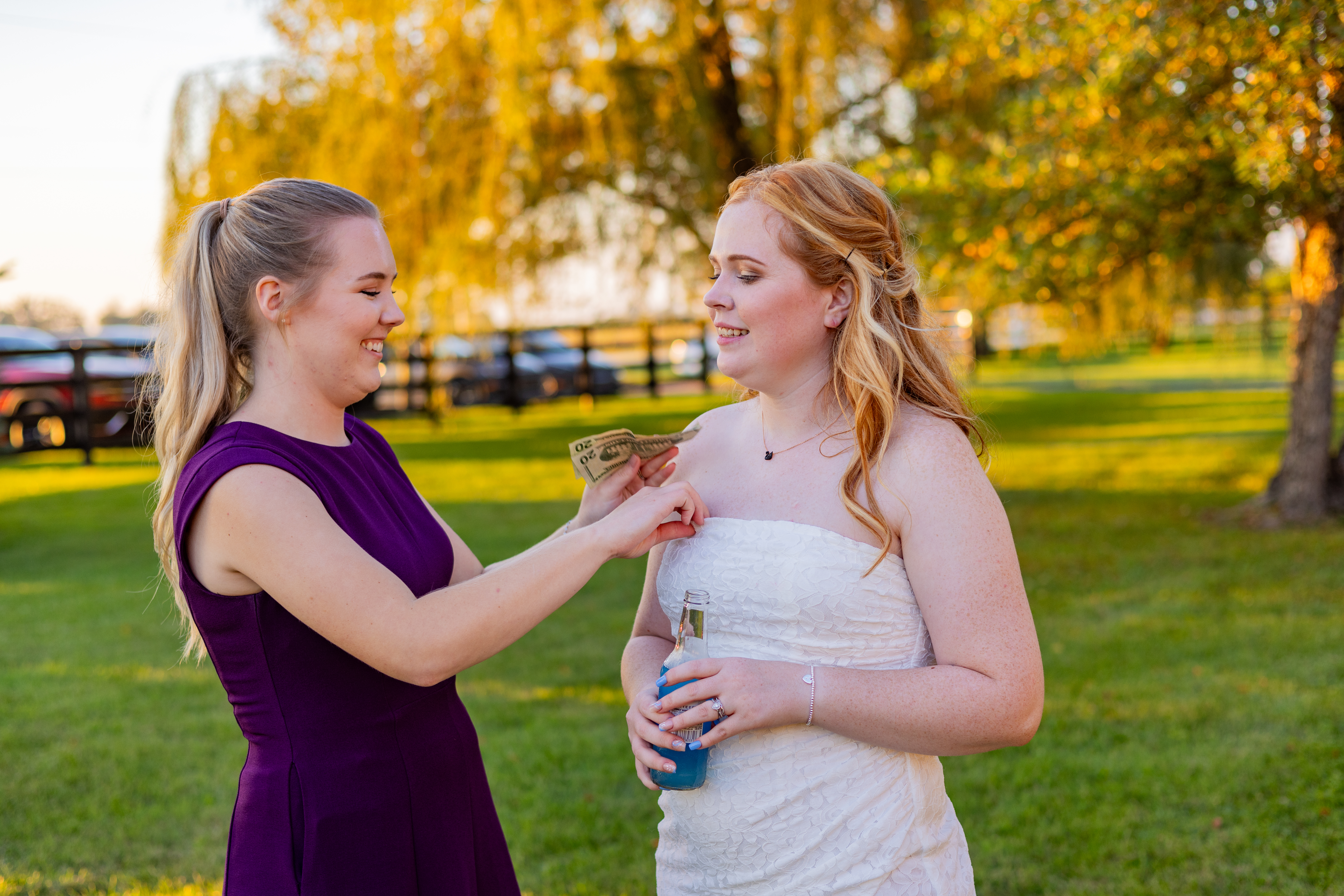 bridesmaid putting cash in bride's dress