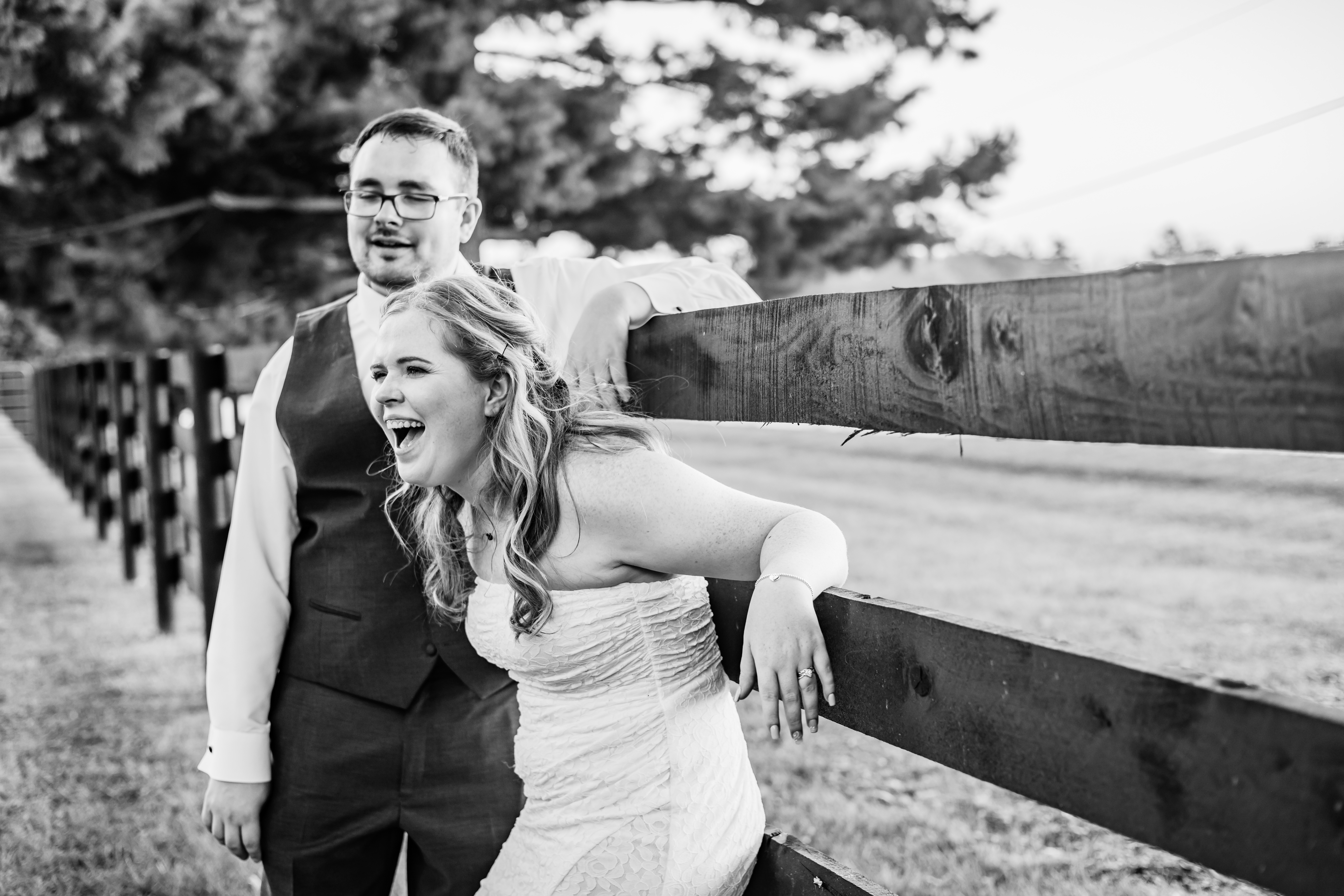 black and white portrait of bride and groom laughing
