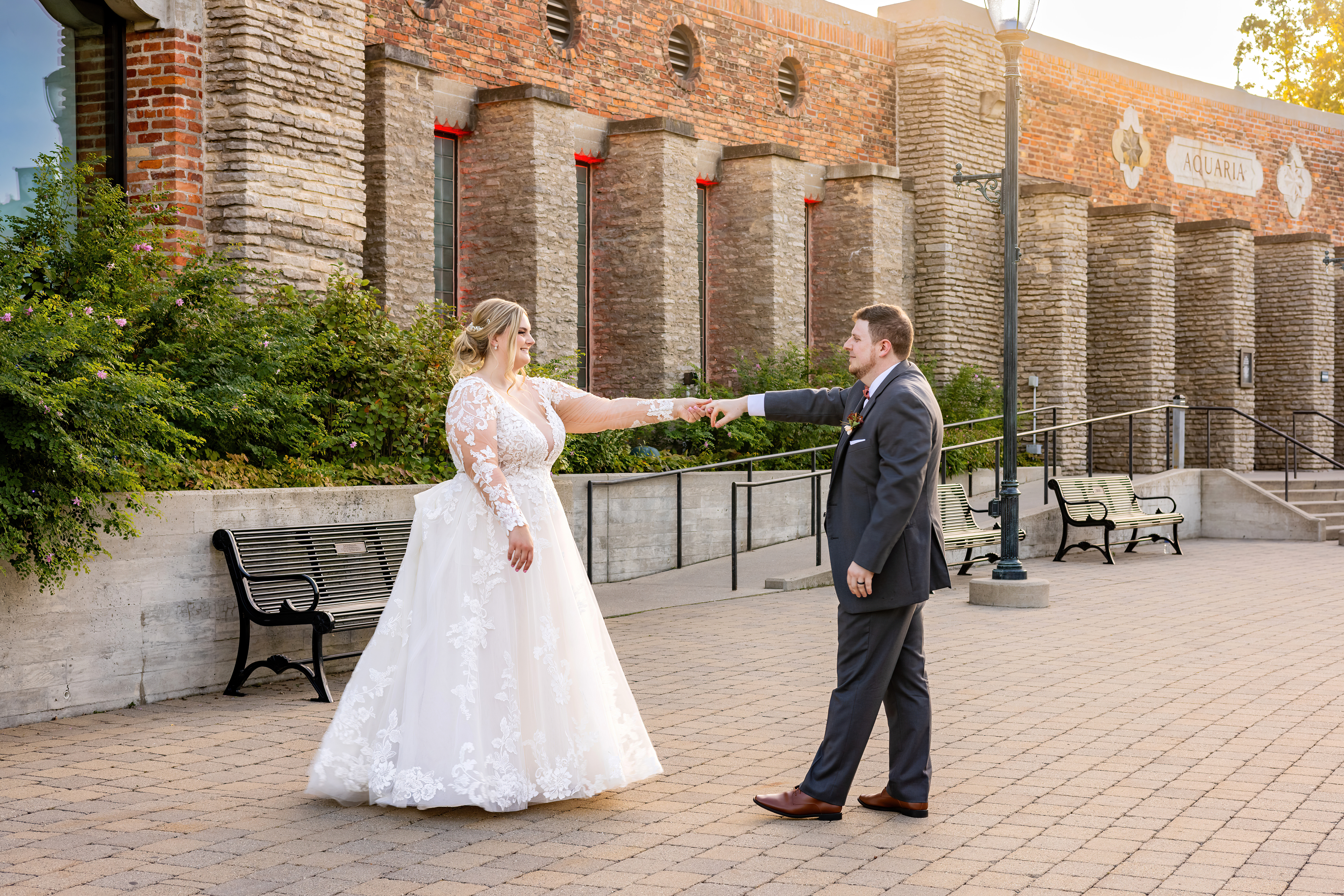 groom twirling bride outside venue