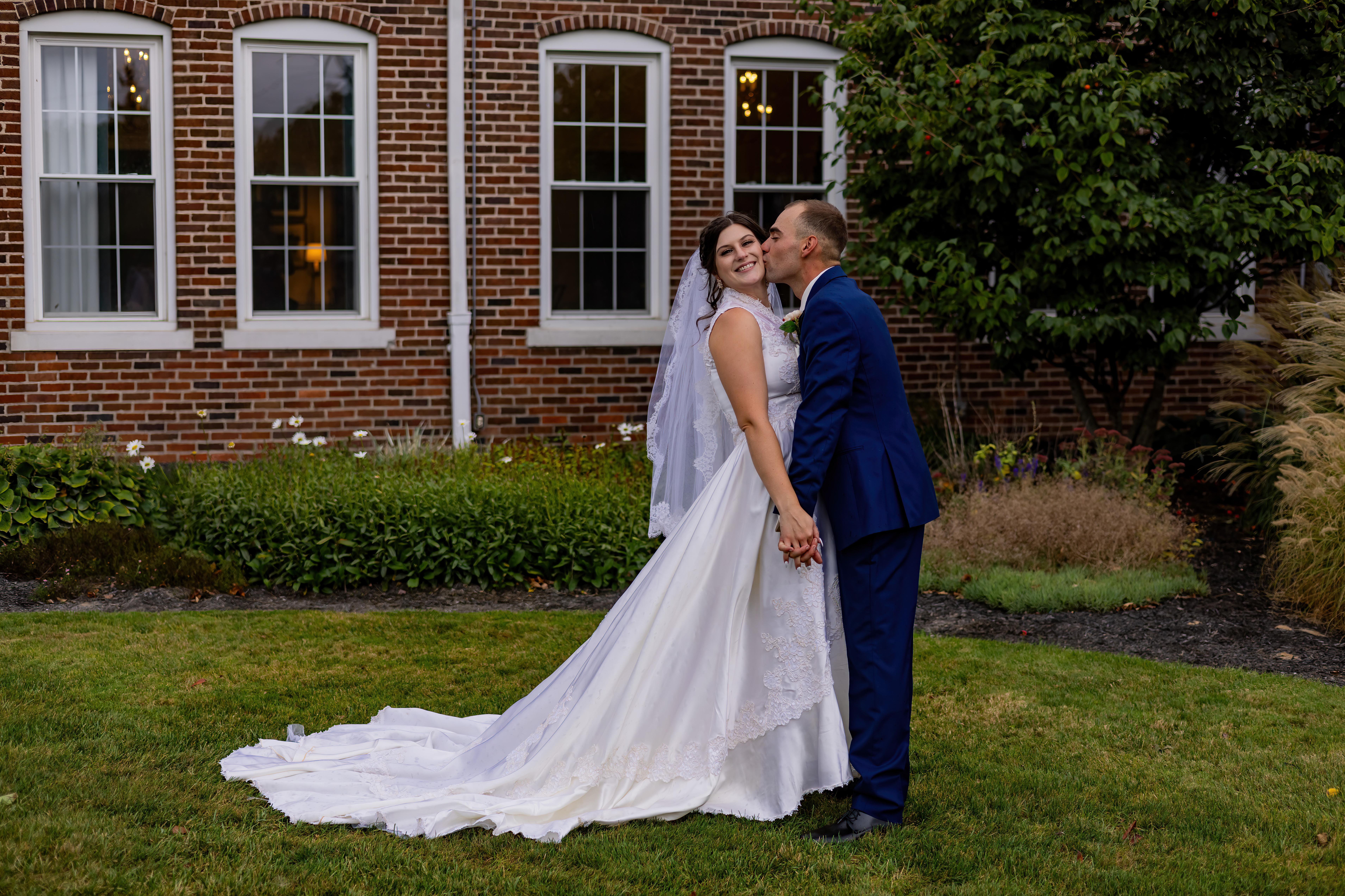 groom kissing bride on the cheek
