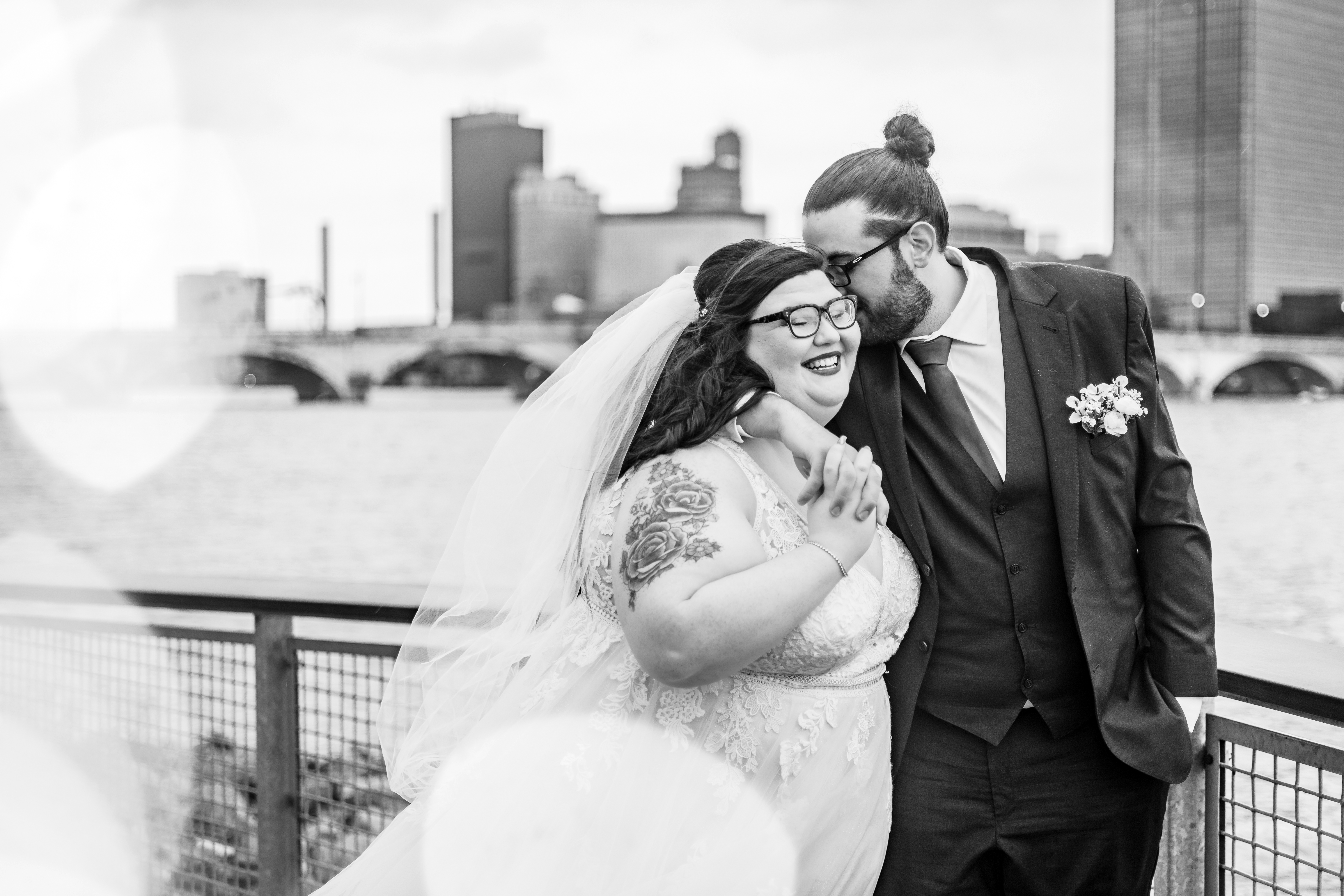 black and white wedding portrait with skyline in backdrop