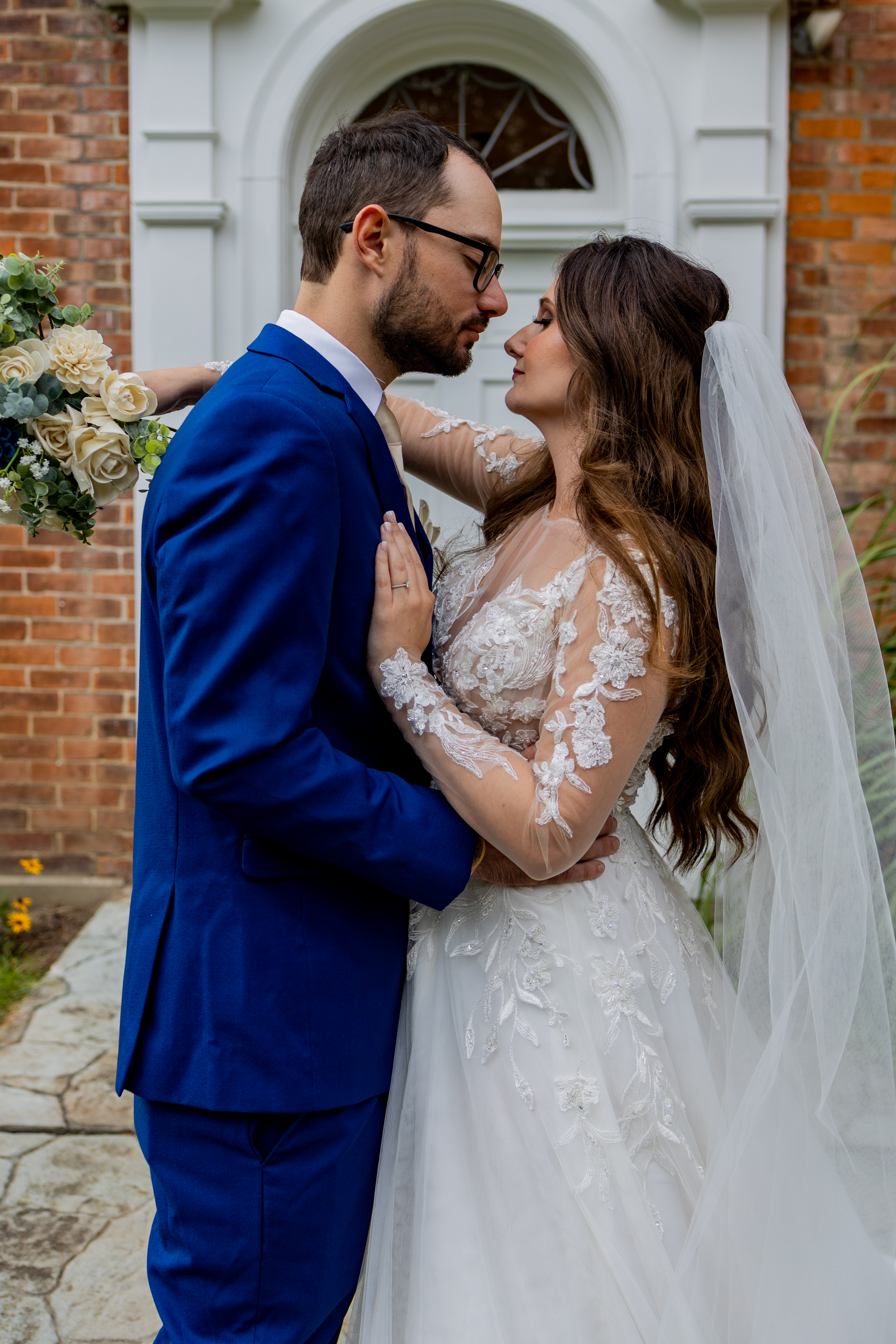 bride and groom embracing in front of church