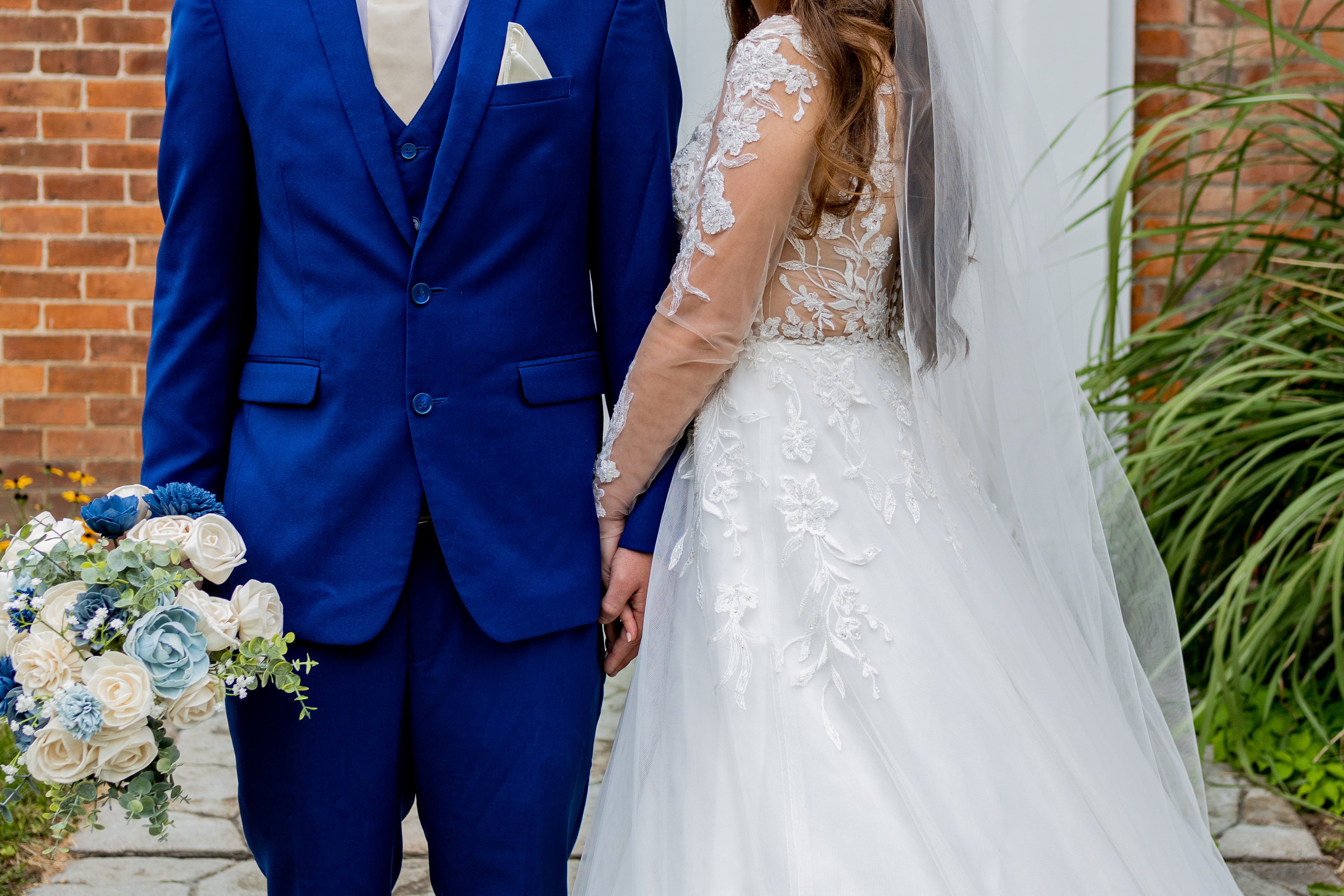 bride and groom holding hands