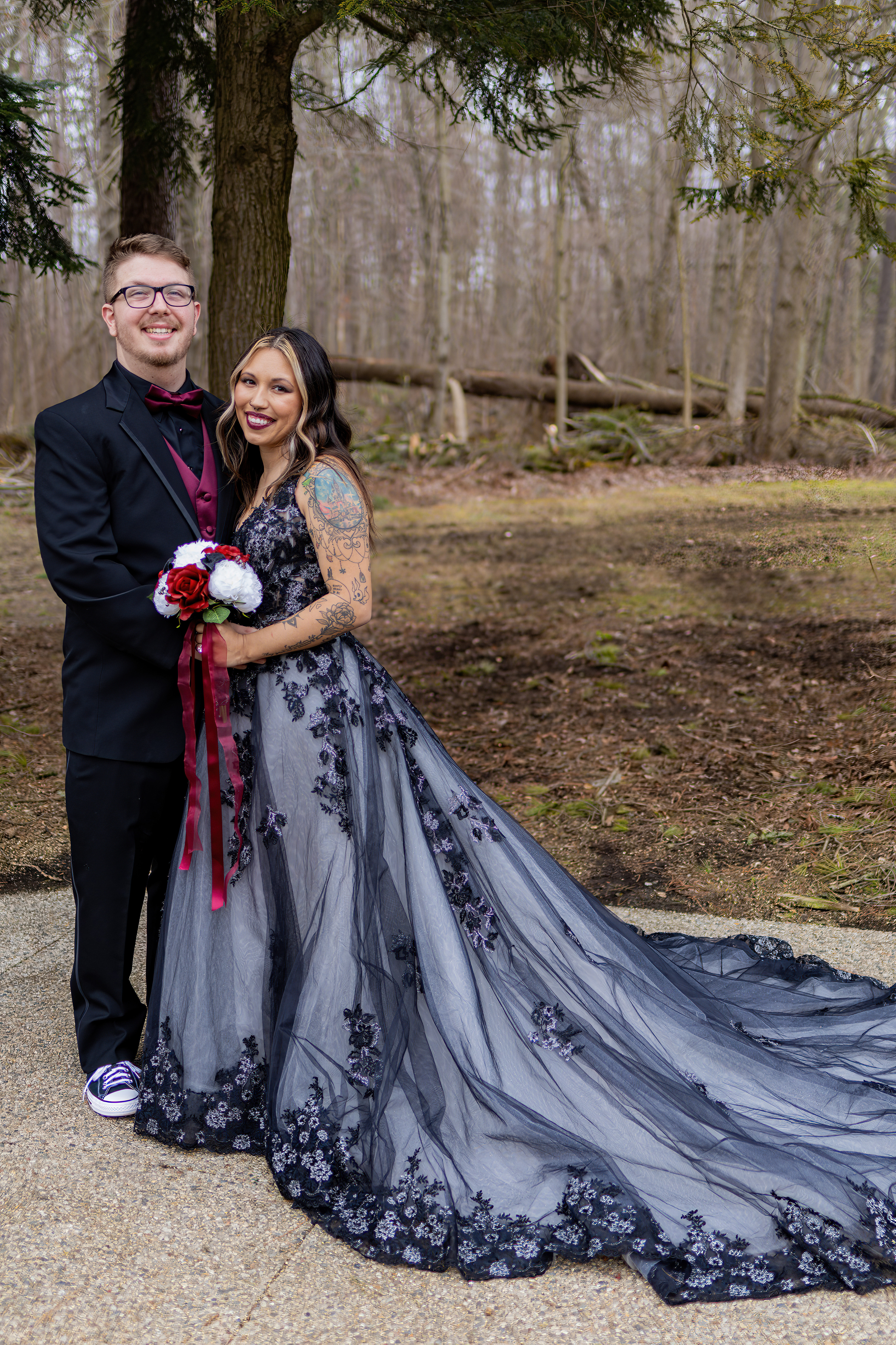 bride in black lace gown smiling with groom