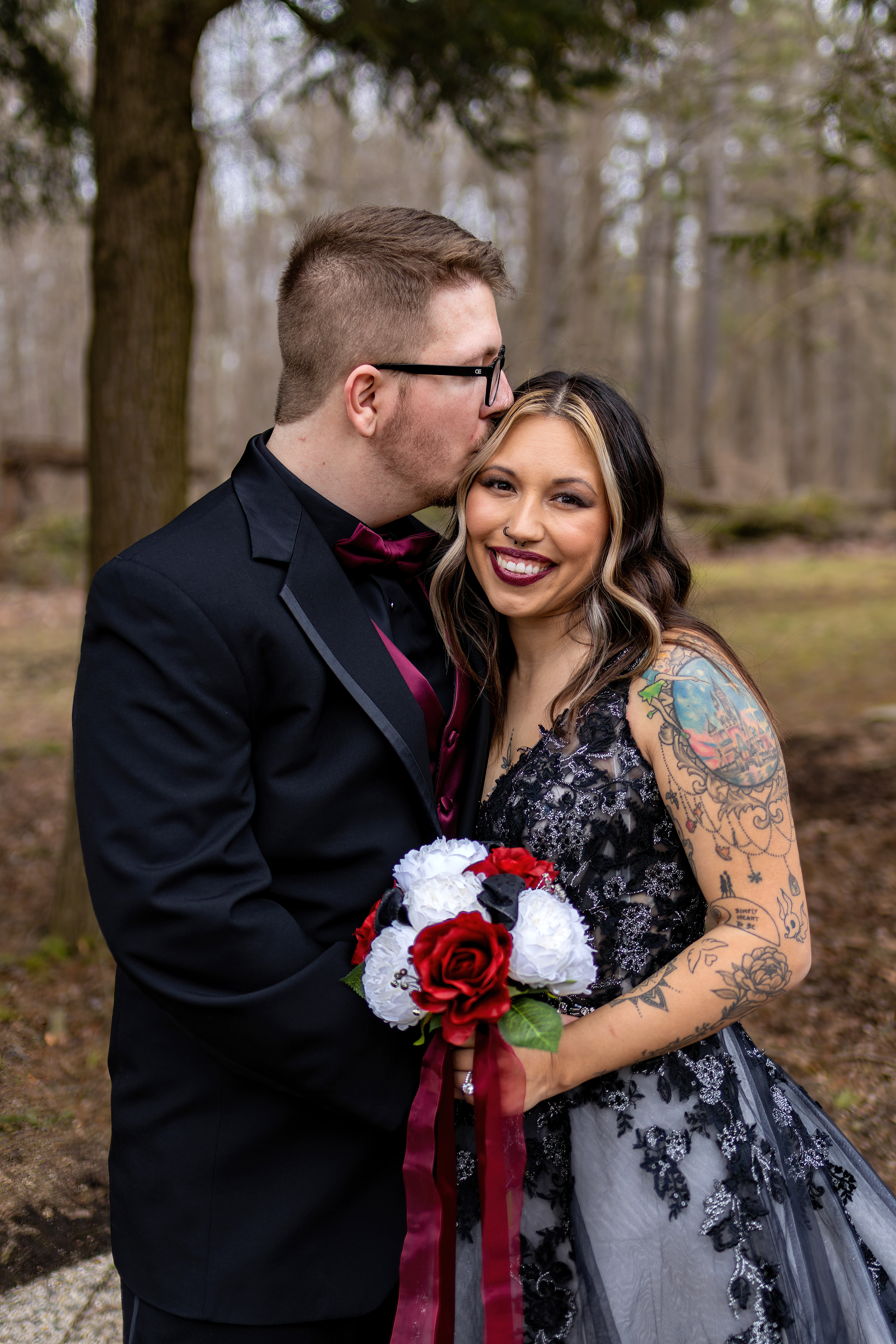 groom kissing bride on forehead