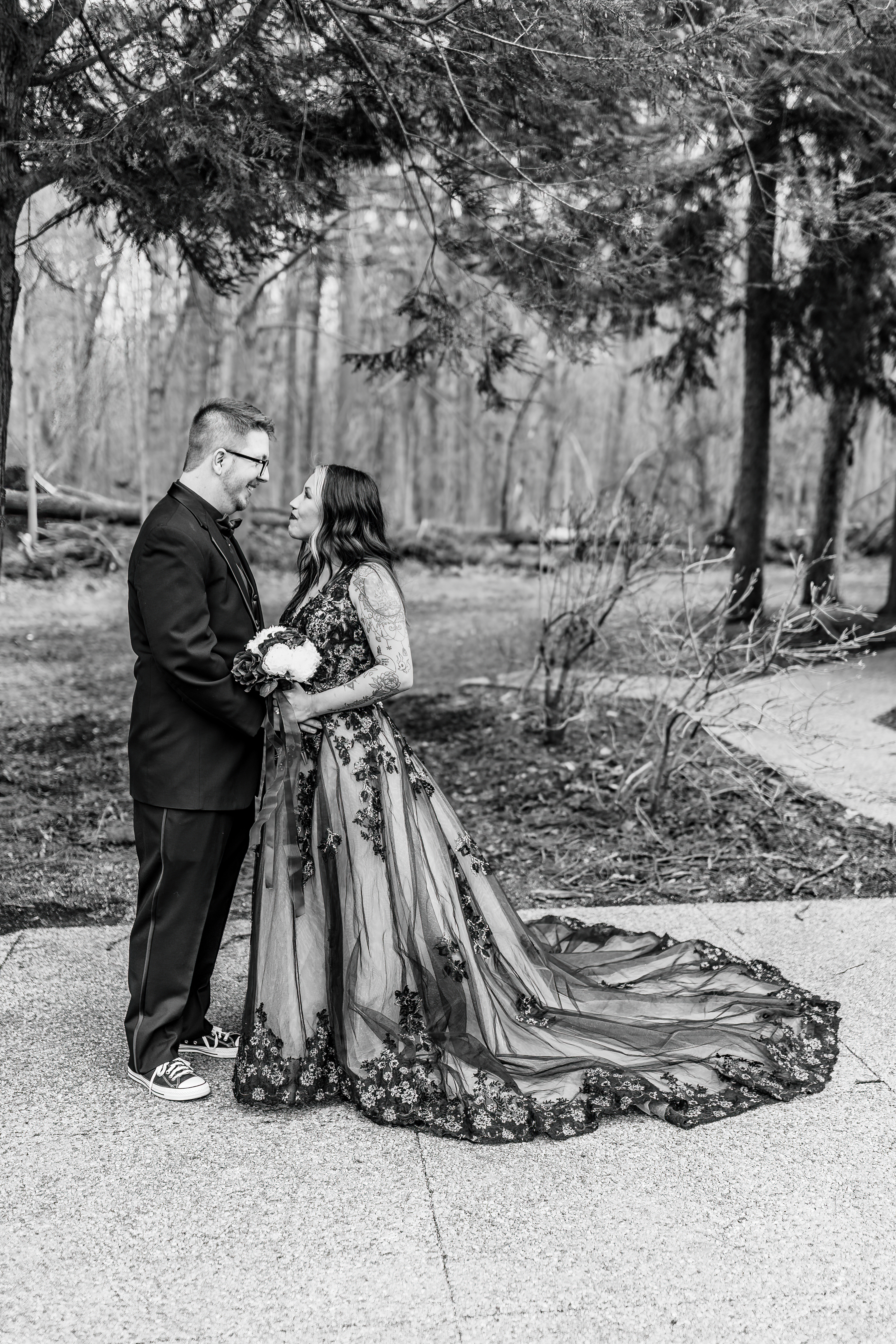 black and white portrait of groom and bride in black lace gown