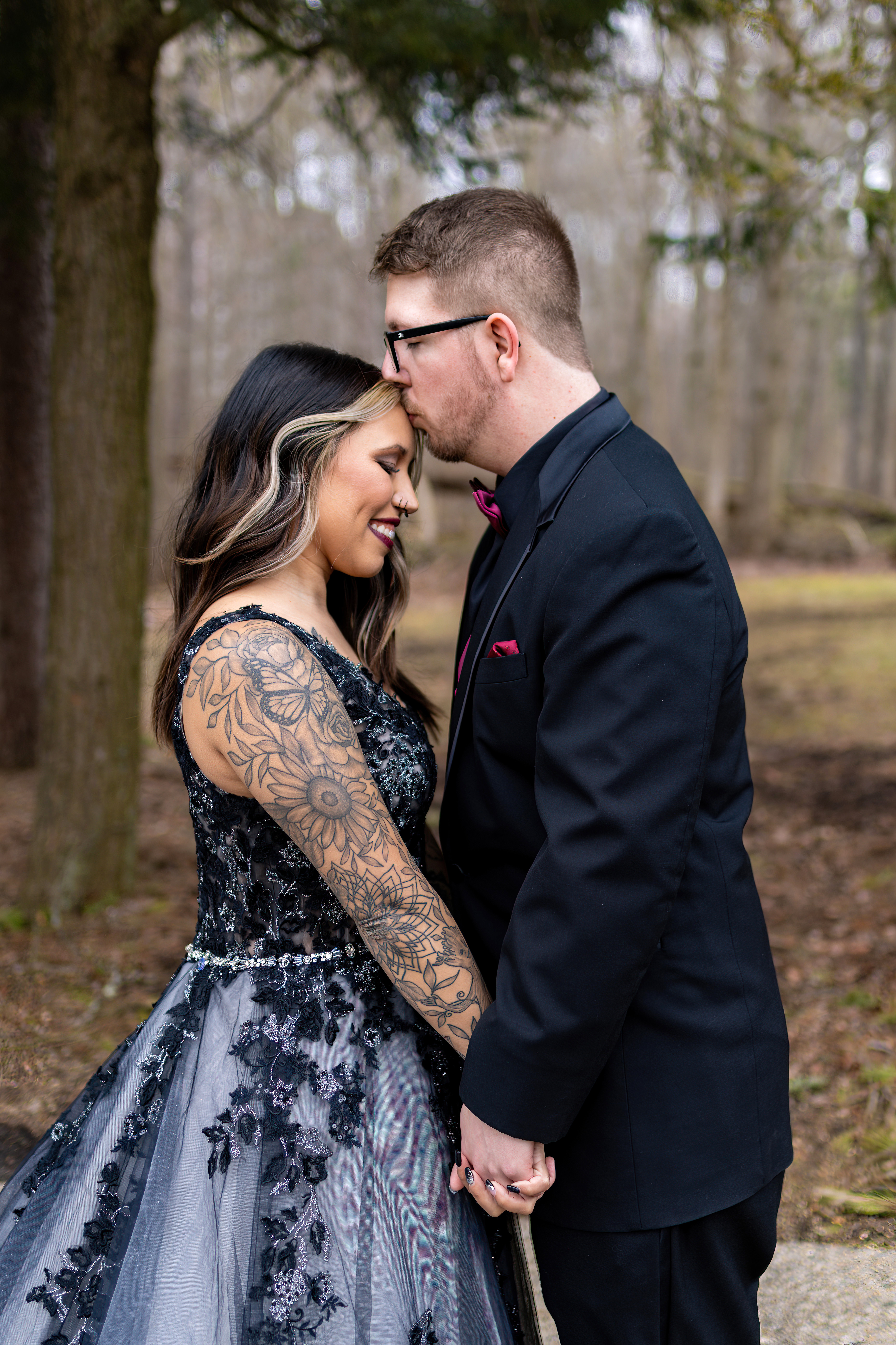 groom kissing bride on the forehead