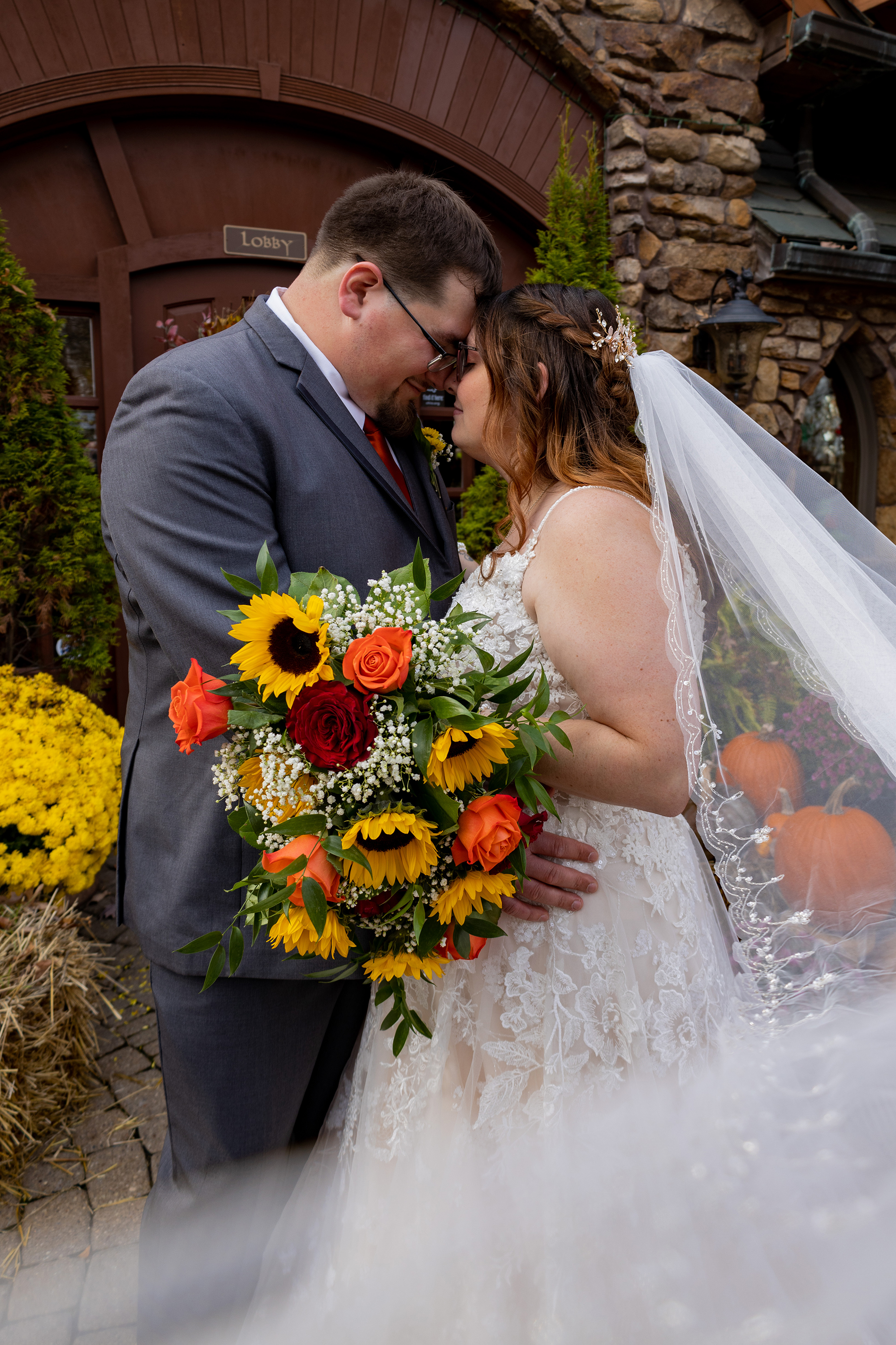 bride and groom embracing during fall wedding