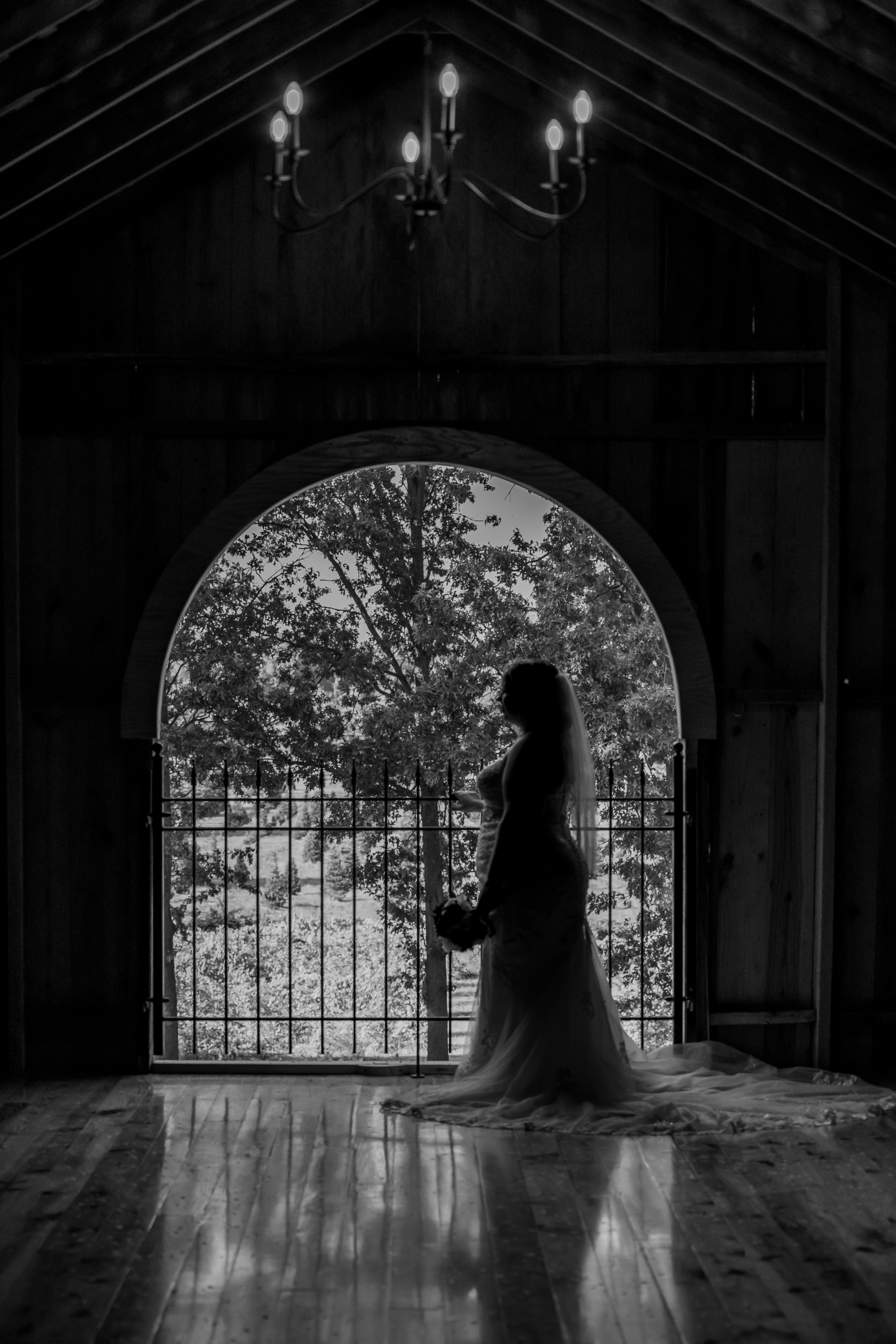 black and white portrait of bride in arched window