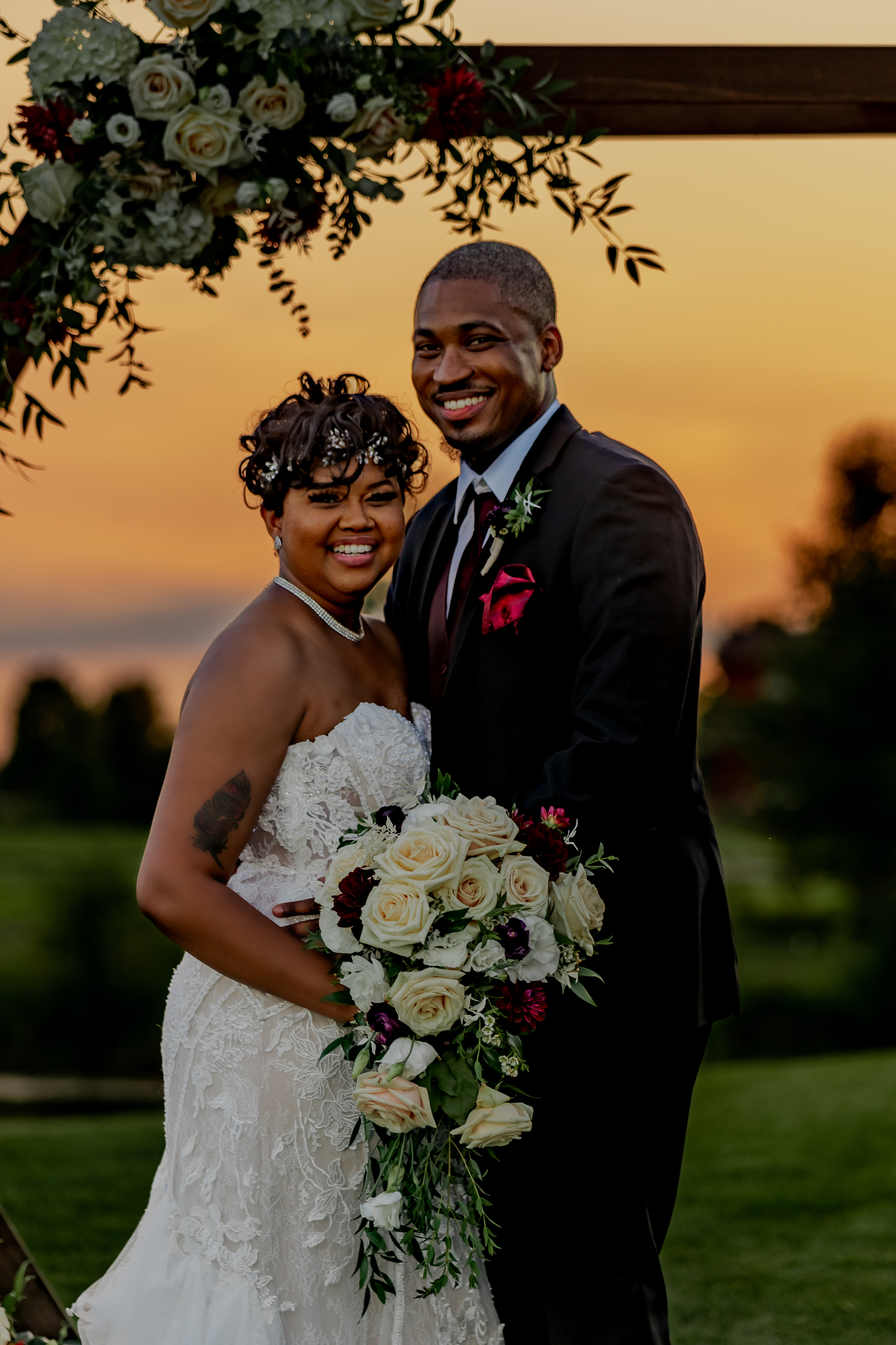 bride and groom embracing at sunset