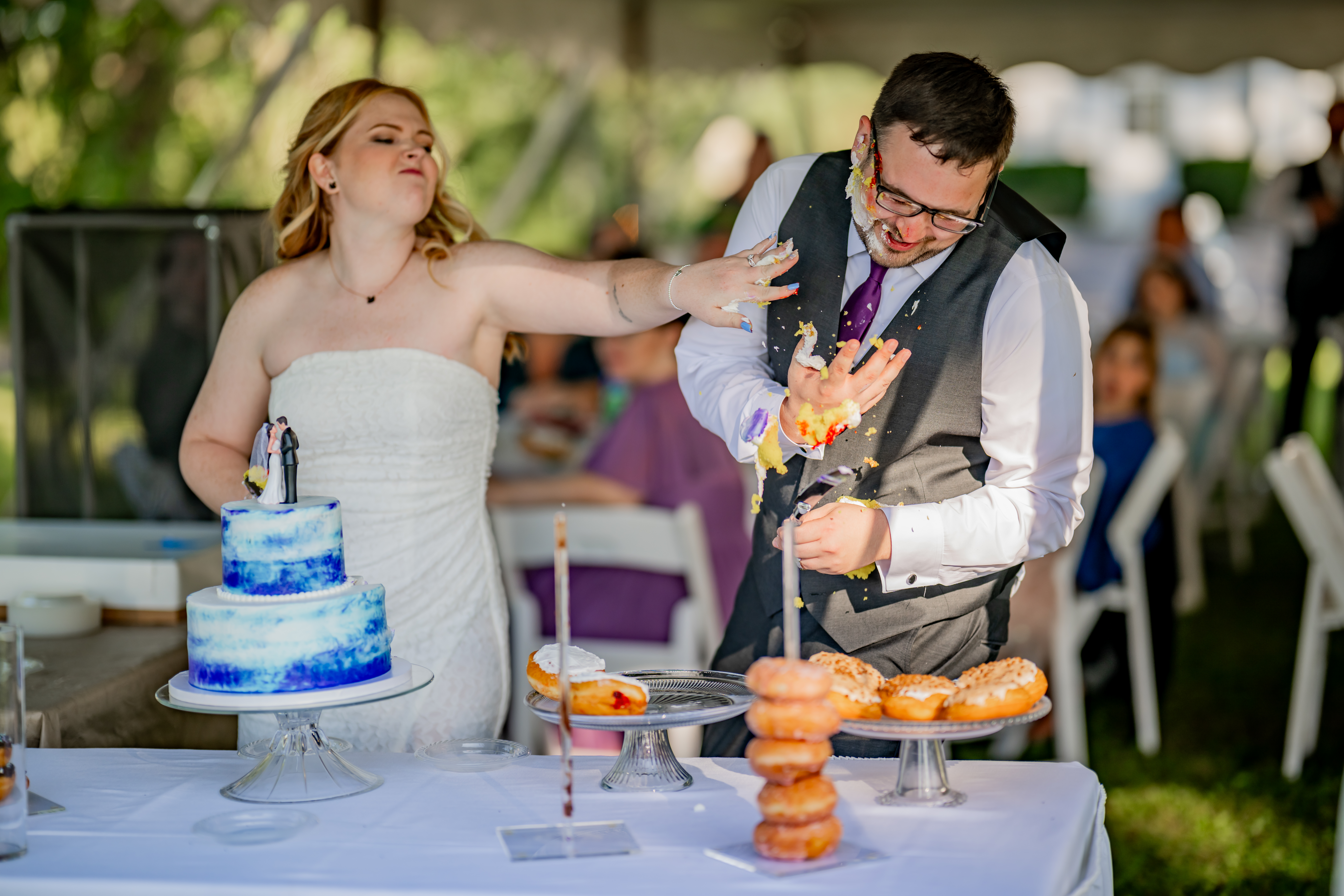 bride throwing cake at groom