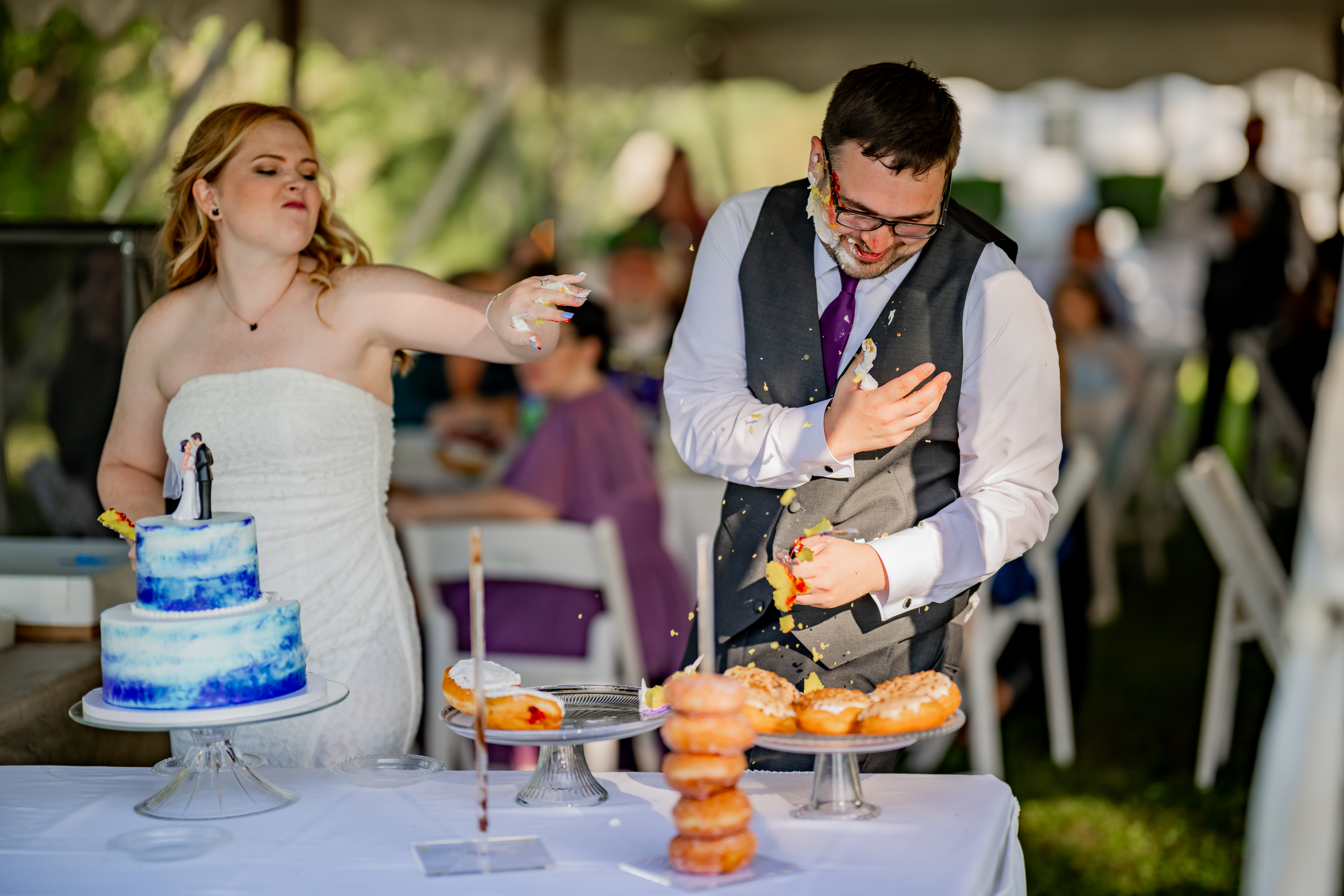 bride throwing piece of cake at groom