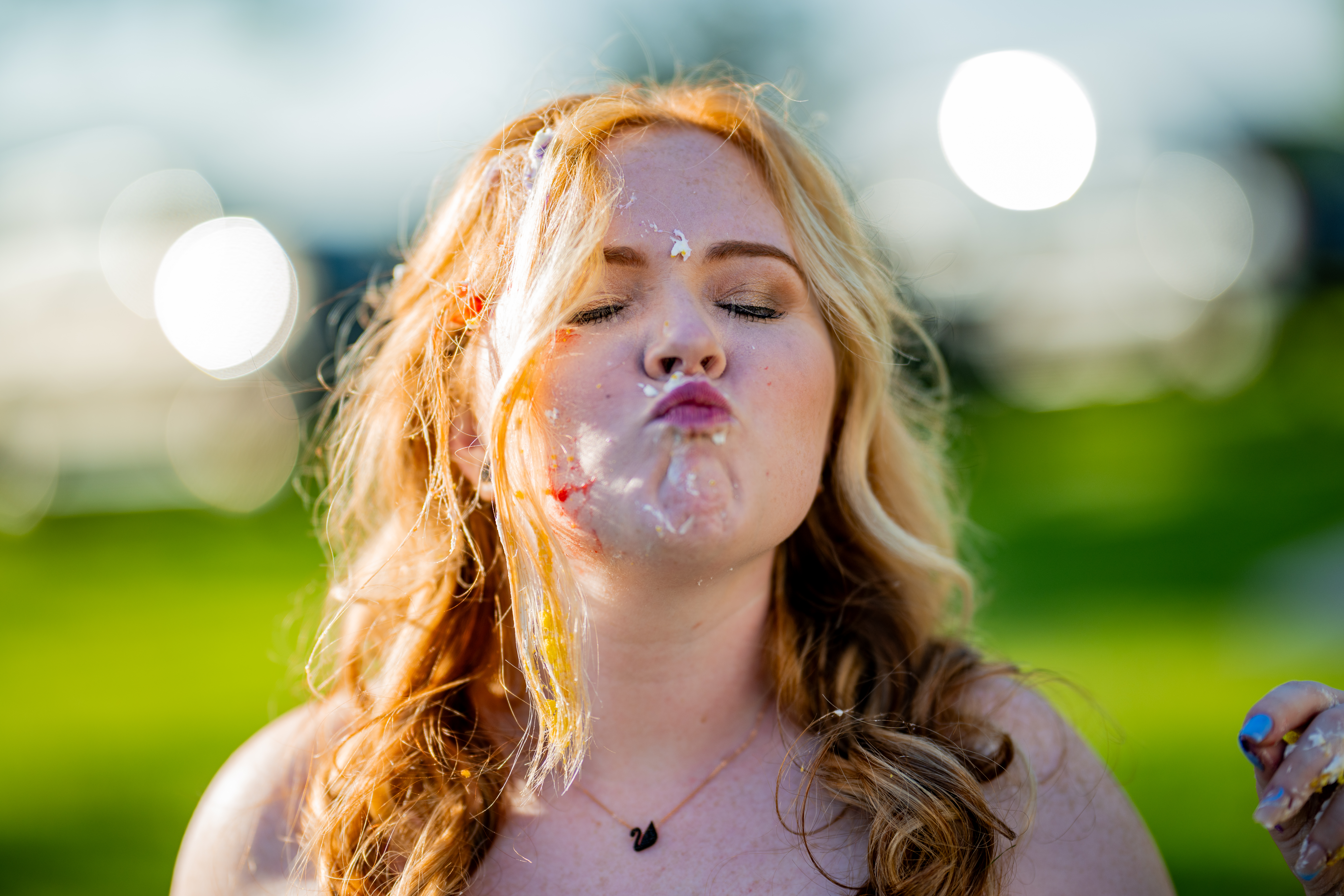 bride with wedding cake on face